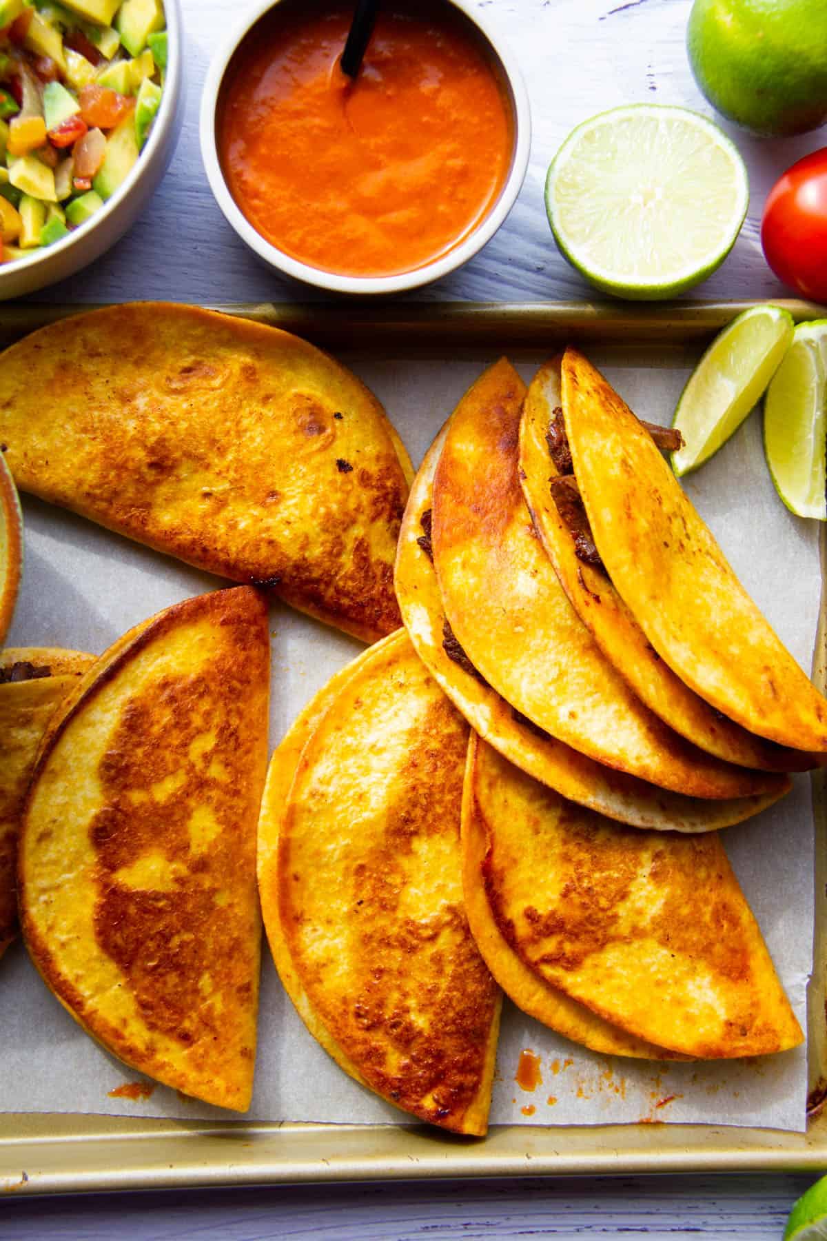 birria tacos with the dipping sauces on the side