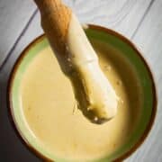 Alabama white bbq sauce in a bowl with a brush.