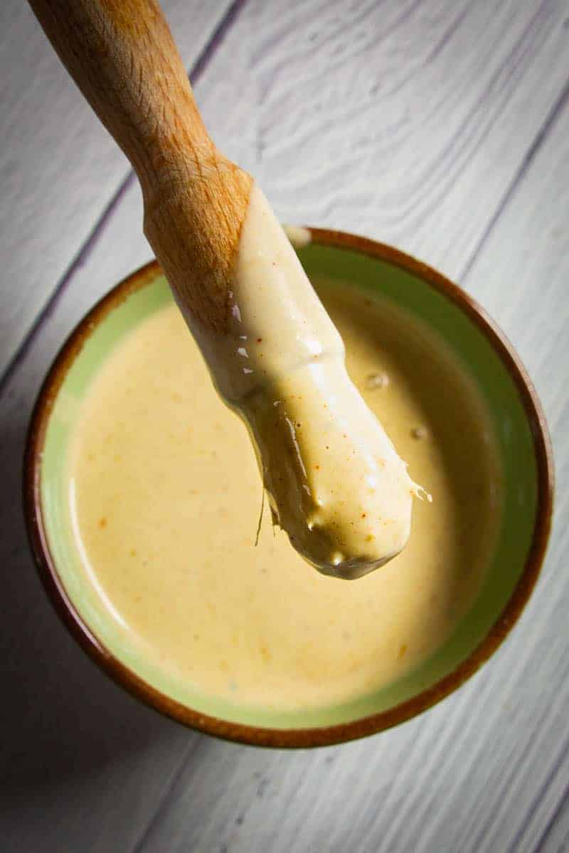 Alabama white bbq sauce in a bowl with a brush.