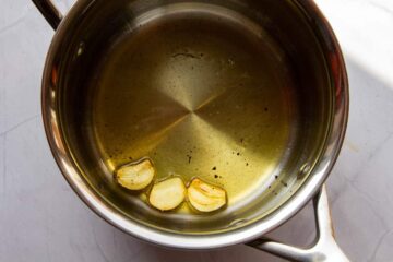 Toasting the peeled garlic in the oil.