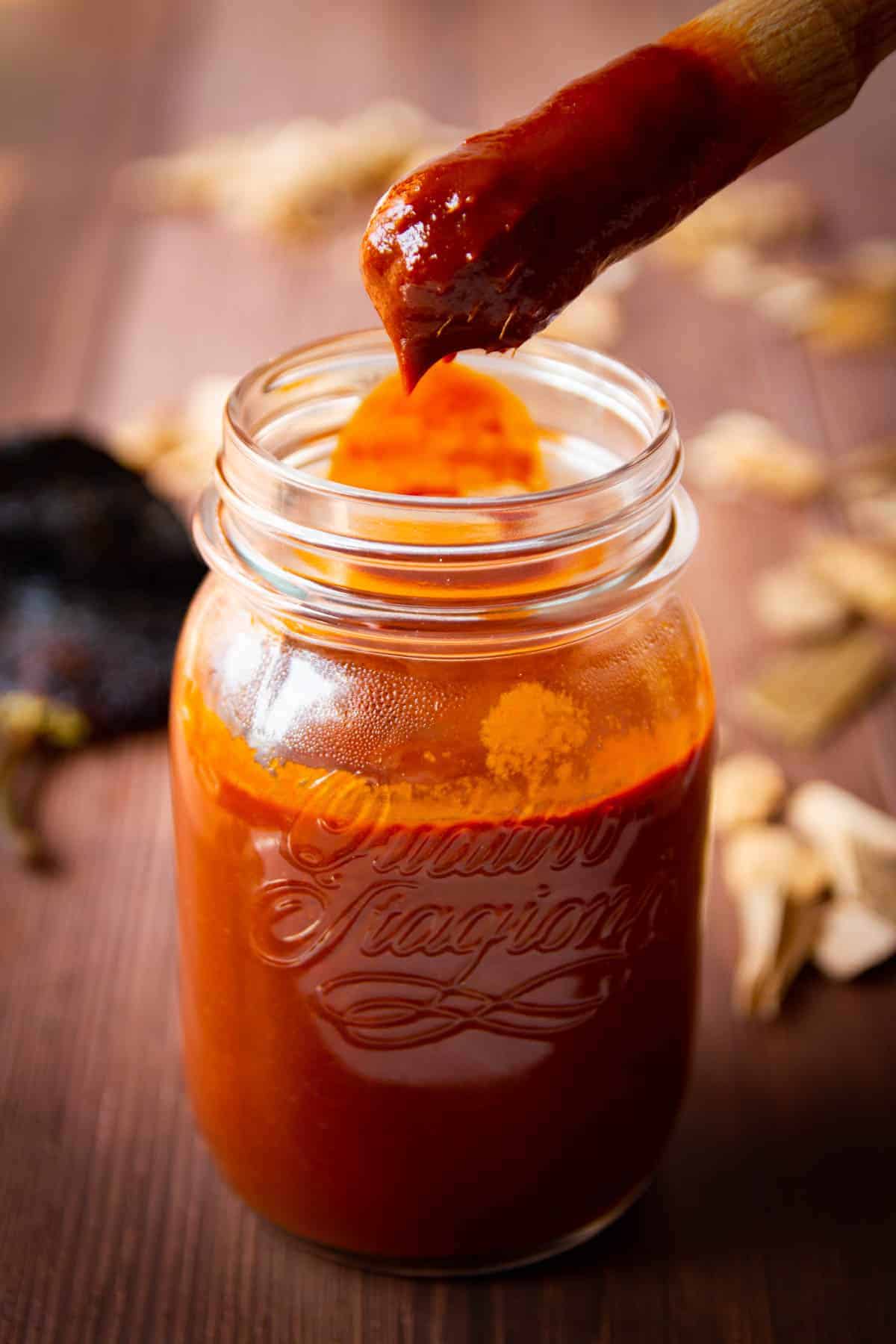 Ancho chili bbq sauce with a brush over top.
