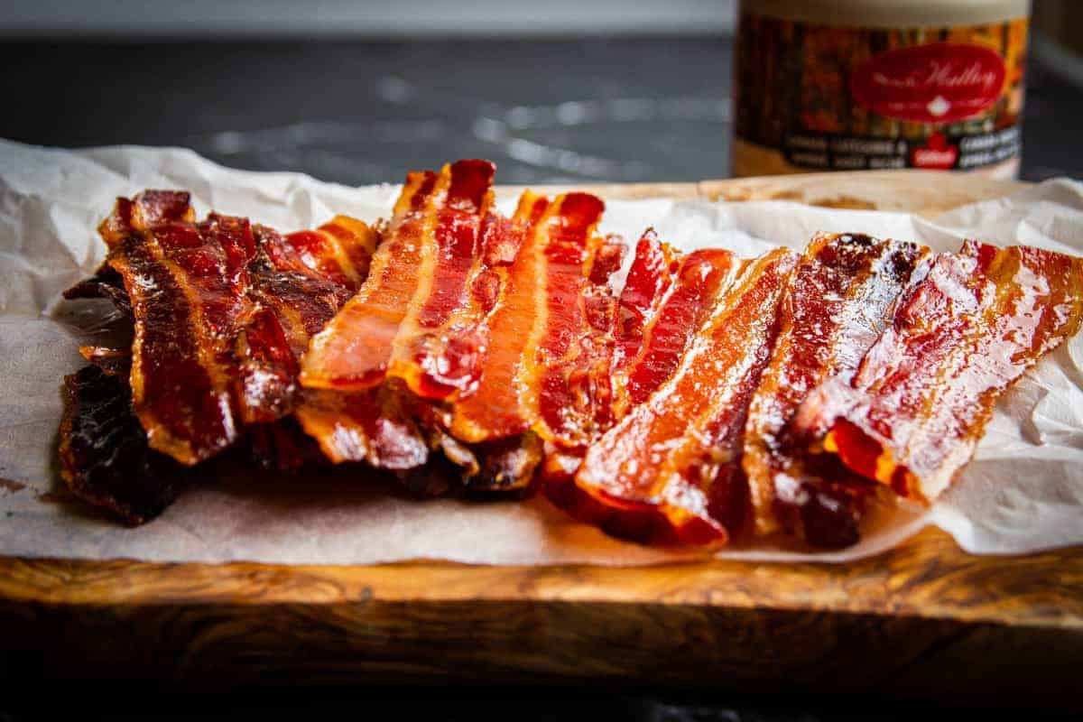 Maple bacon sitting on a wooden board.