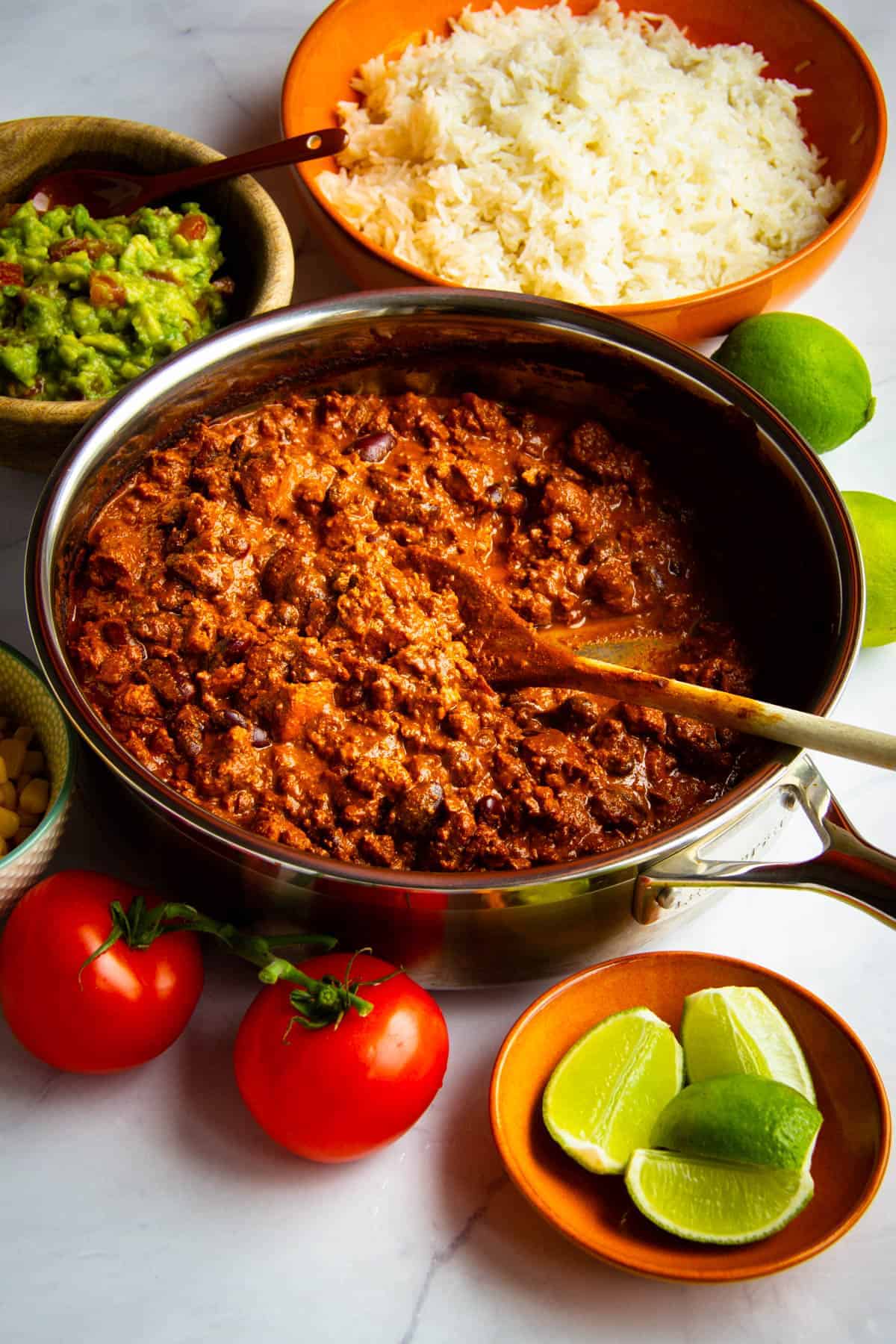 Sofritas in the pan with rice and guac around.