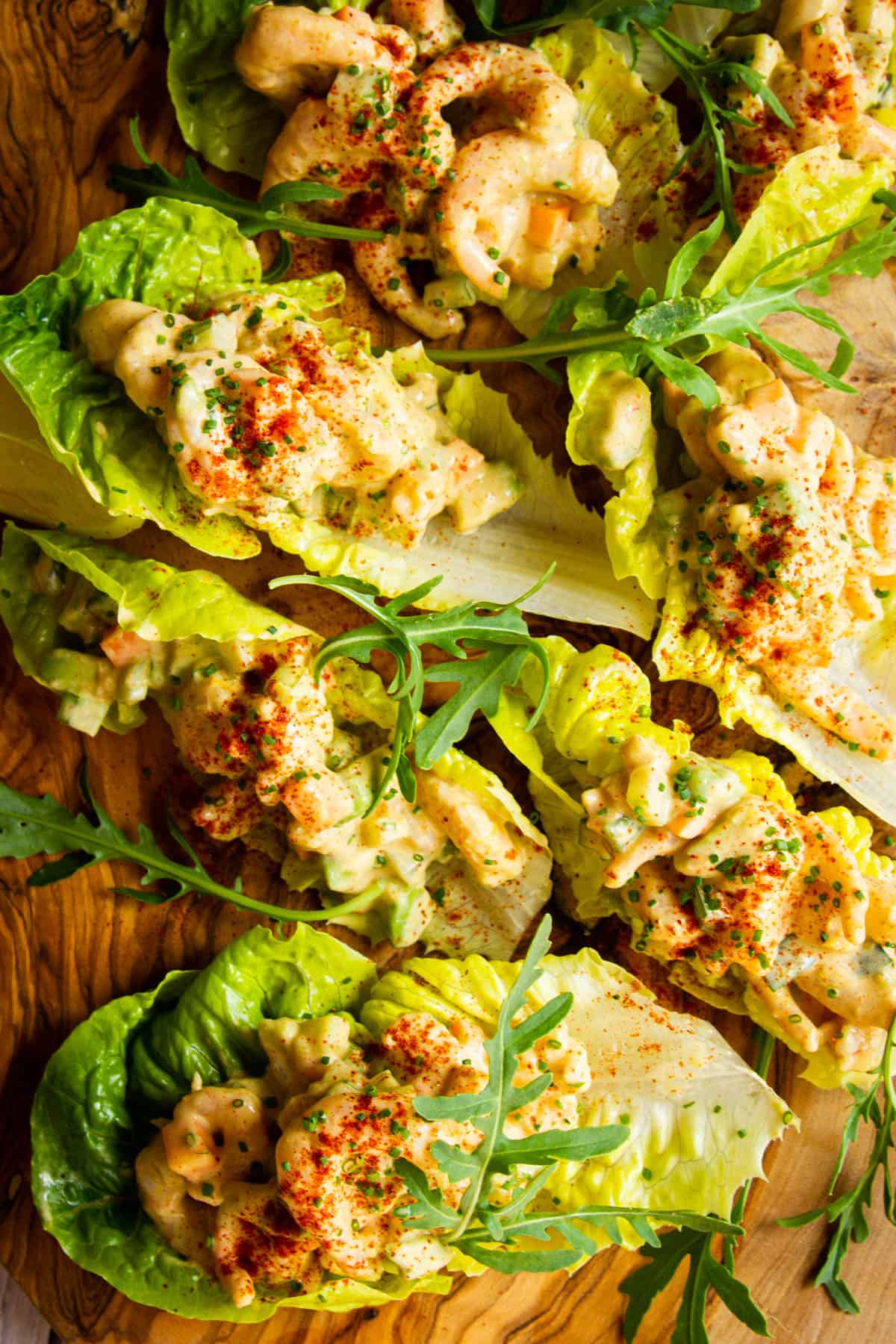 Another close up shot of the baby shrimp salad lettuce wraps on a board.