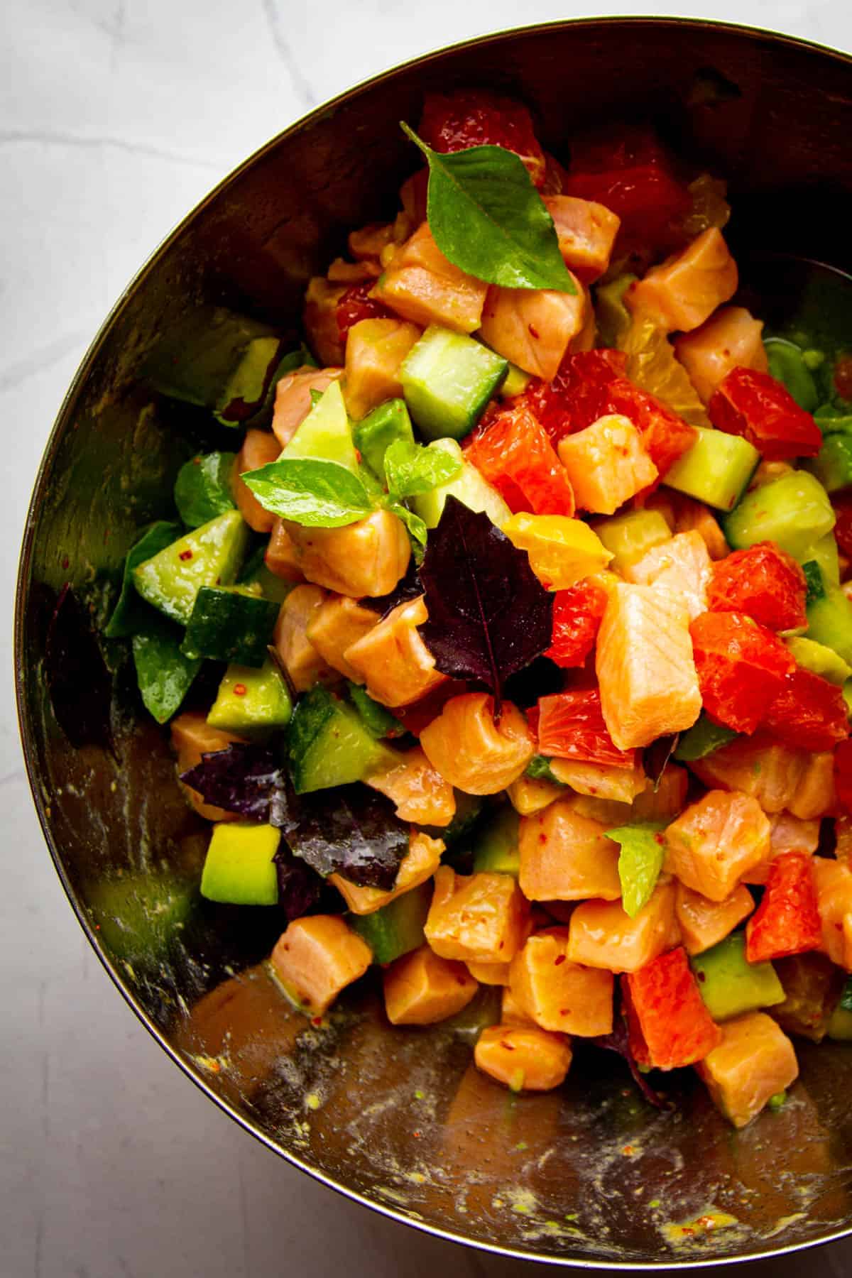 A close up of the salmon ceviche in the mixing bowl.