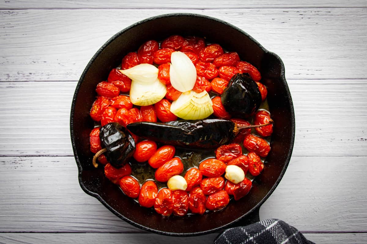 The roasted tomatoes and onions in the pan.