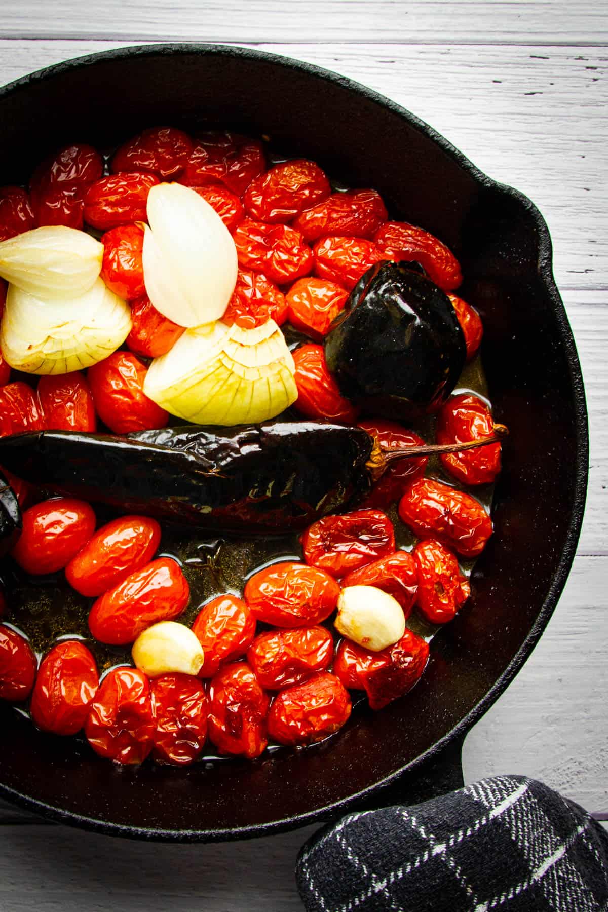 The ingredients for the salsa in a cast iron pan.