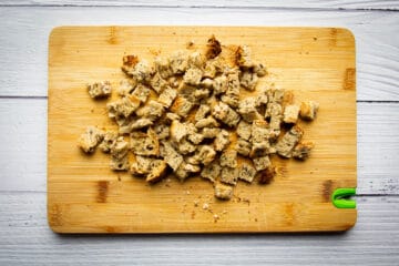 Cutting the croutons into little squares.