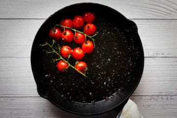 Frying the cherry tomatoes in the pan.