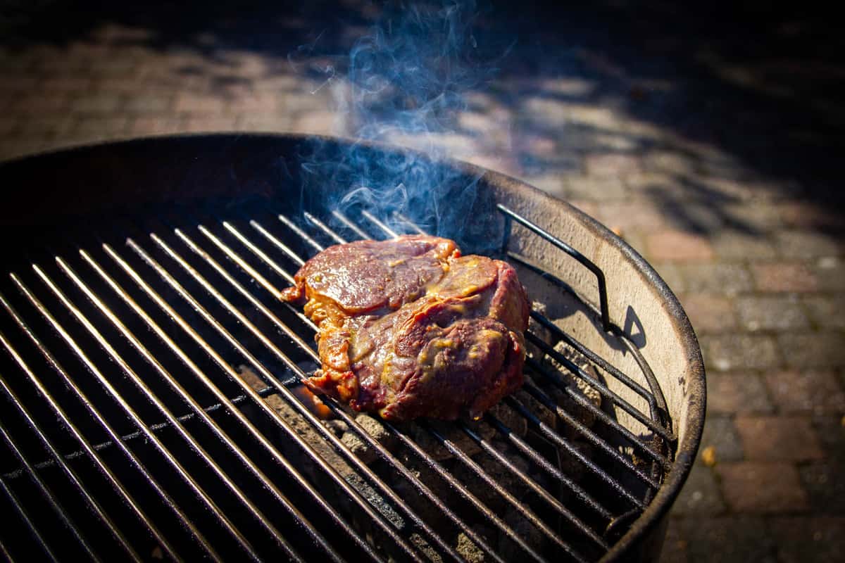 Searing the smoked ribeye over high heat.