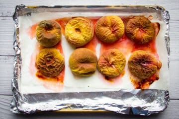 The roasted peaches on a tray.