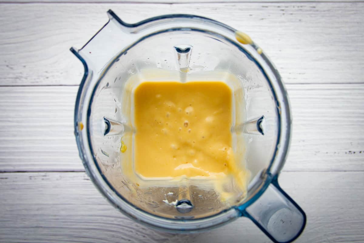 The blended peach puree in a blender.