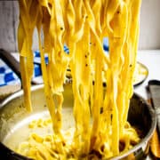 Tagliatelle cacio e pepe lifted out of the pan.