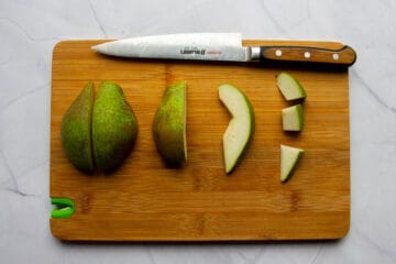 Slicing the pear into small pieces.