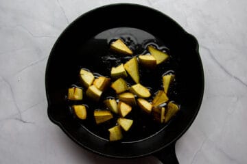 Browning the pears in butter in a cast iron pan.