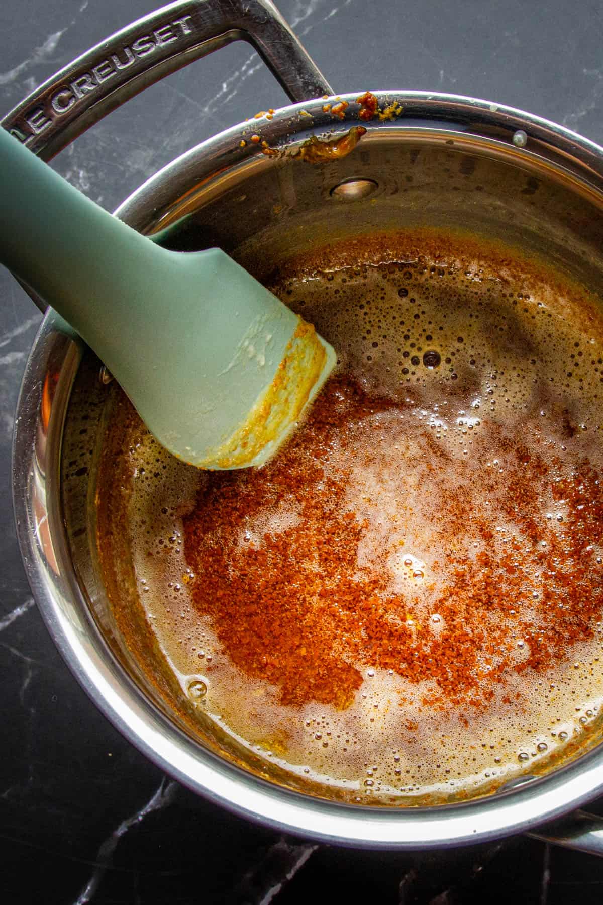 A close up of the caramelized cream in a pan.