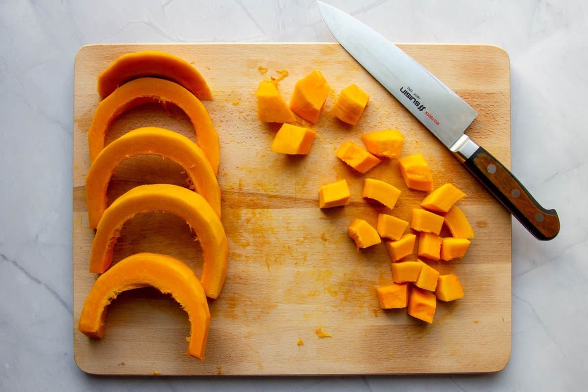 Cutting the squash into even sized pieces.