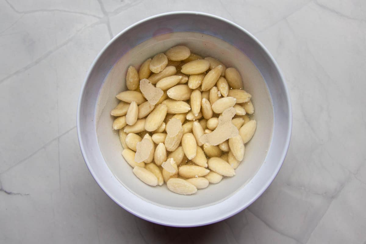 Soaking the almonds in water overnight.