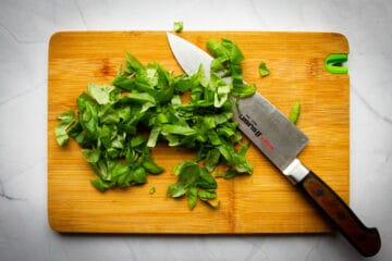 The chopped basil on a cutting board.