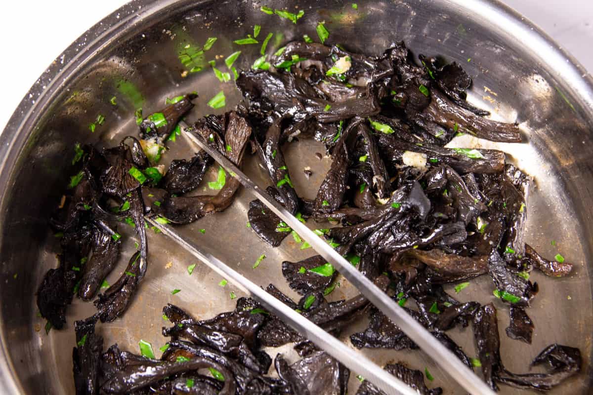 Cooking the black trumpet mushrooms with tarragon and garlic.