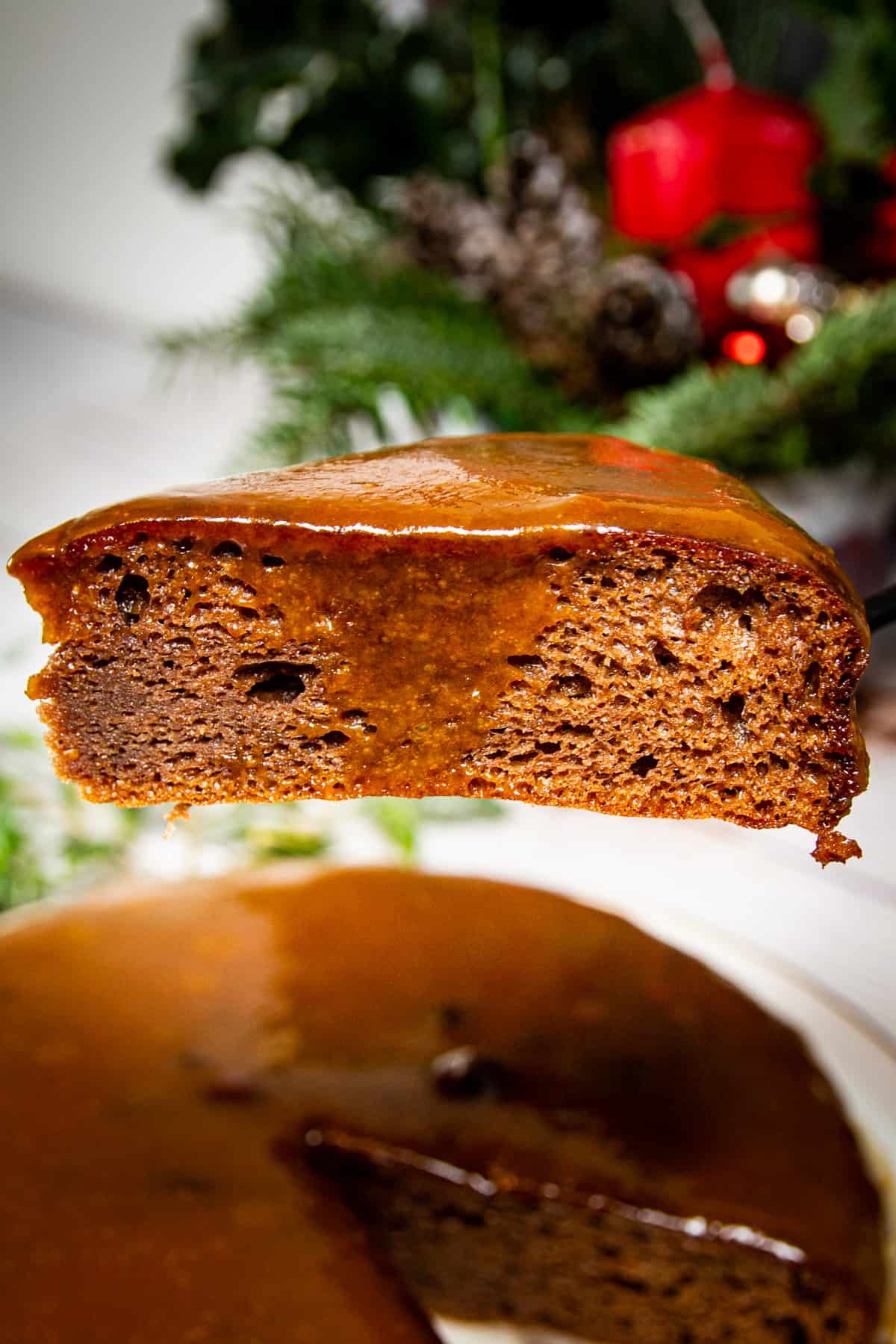 The ultimate keto sticky toffee pudding sitting high on a fork.