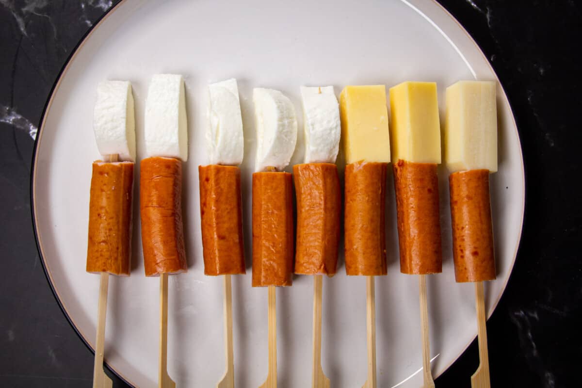 Hotdogs and cheese on sticks, ready to be battered.