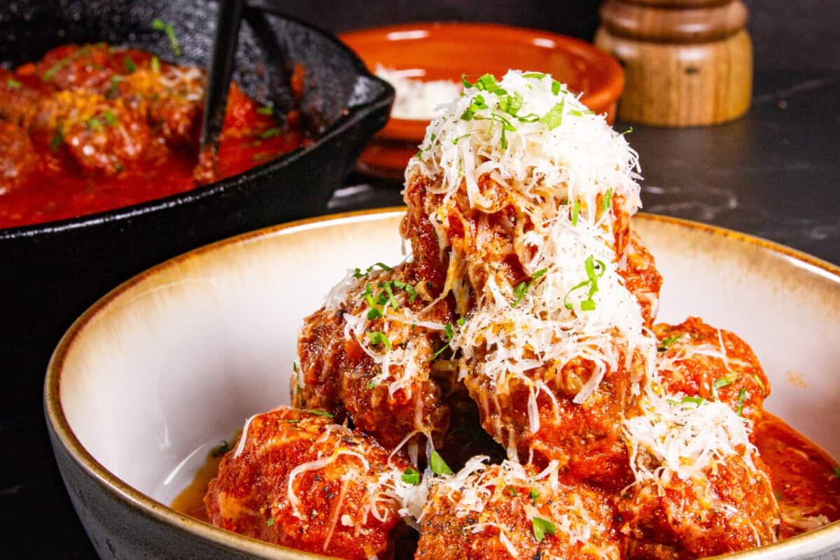 Meatballs without breadcrumbs stacked high on a plate.