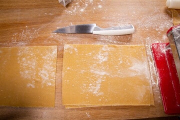 Cutting the pasta into sheets.