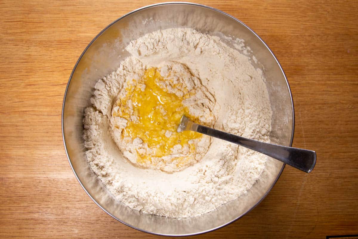 Mixing the flour slowly into the eggs.