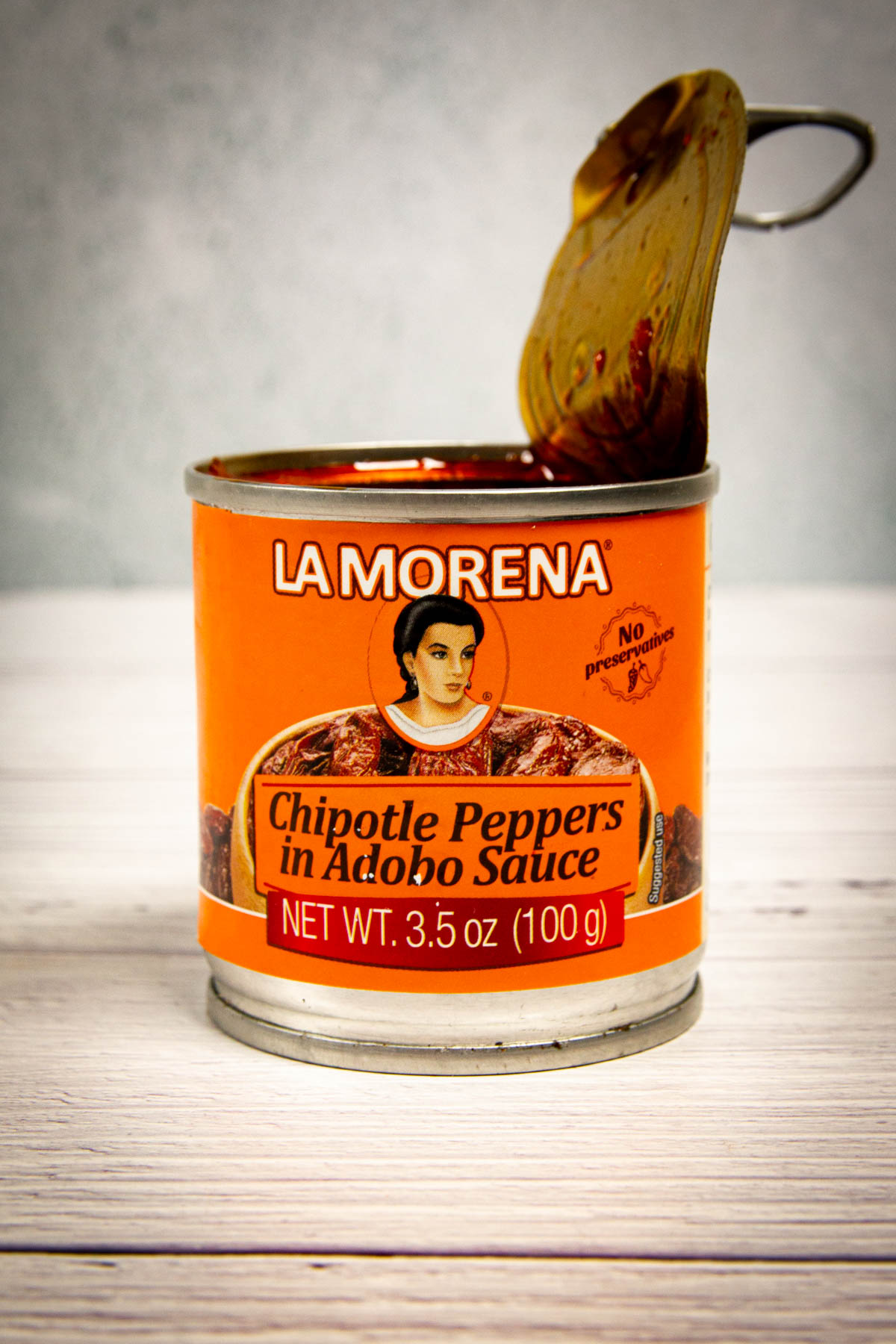 An opened can of la morena chipotle peppers.