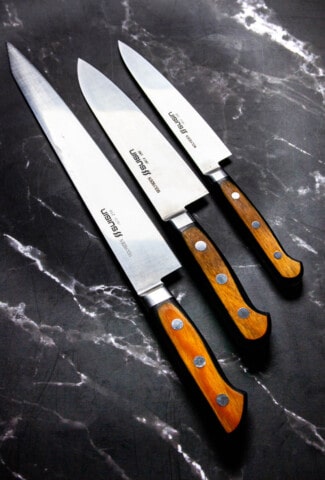 3 piece suisin knife set on a marble table.