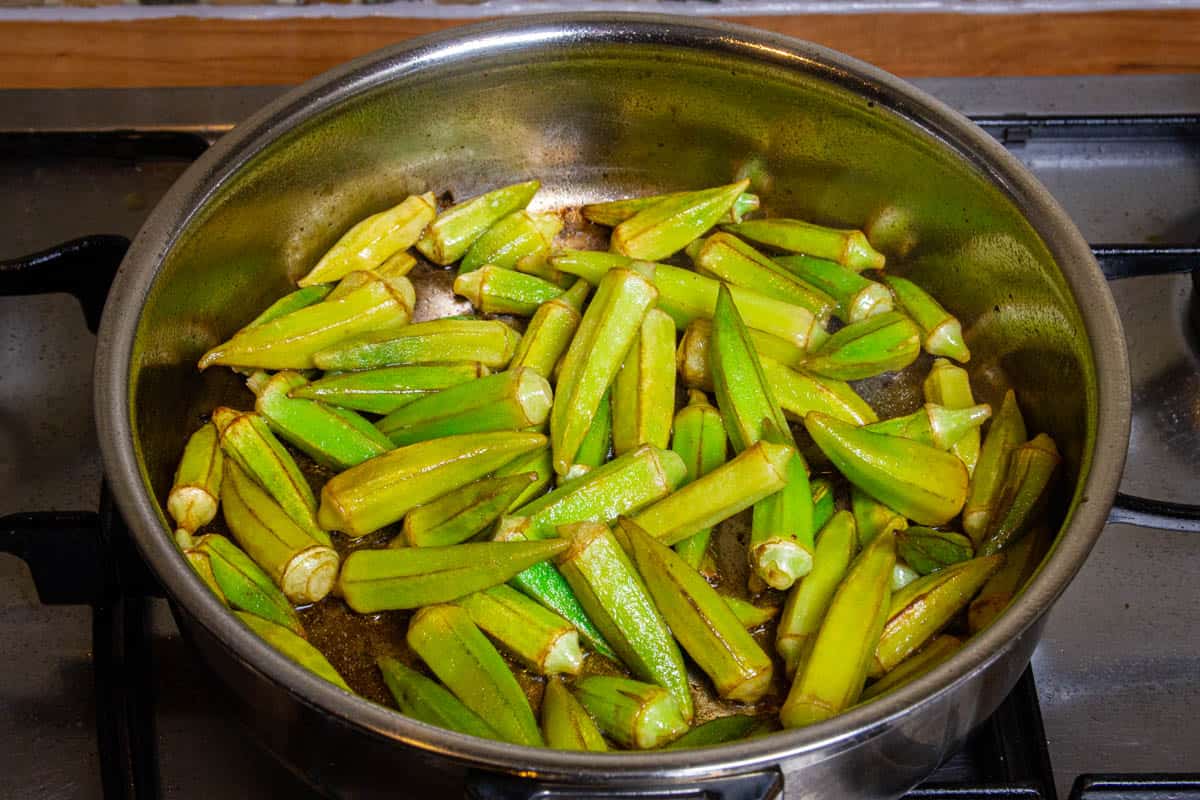 The okra in the pan turning golden brown.