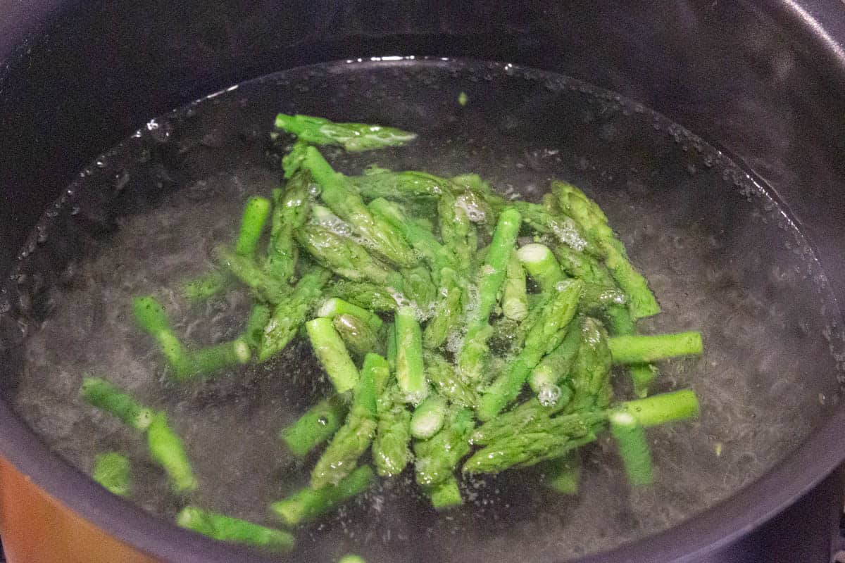 Boiling the asparagus in salted water.