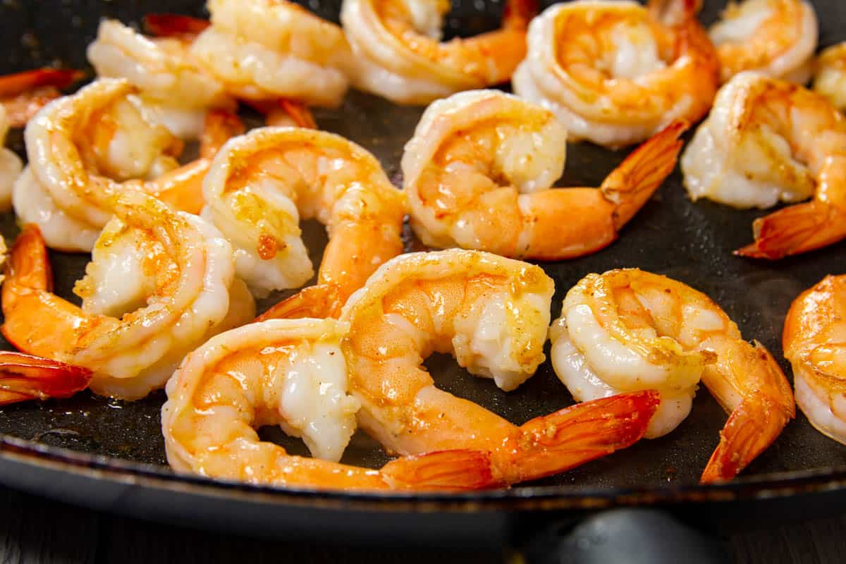 Frying the shrimp in a saute pan.