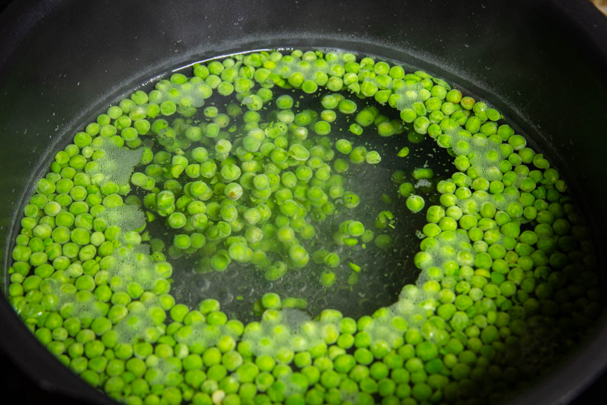 Blanching the peas in a big pot of boiling water.