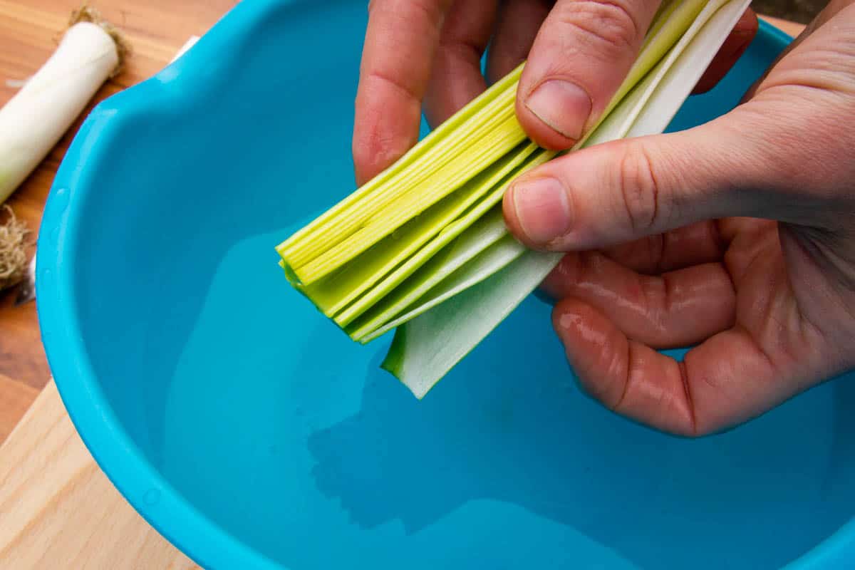 Washing the leeks really well in a bowl of cold water.