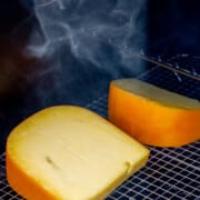 Two large blocks of gouda cheese smoking on the Traeger.