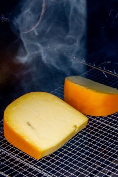 Two large blocks of gouda cheese smoking on the Traeger.