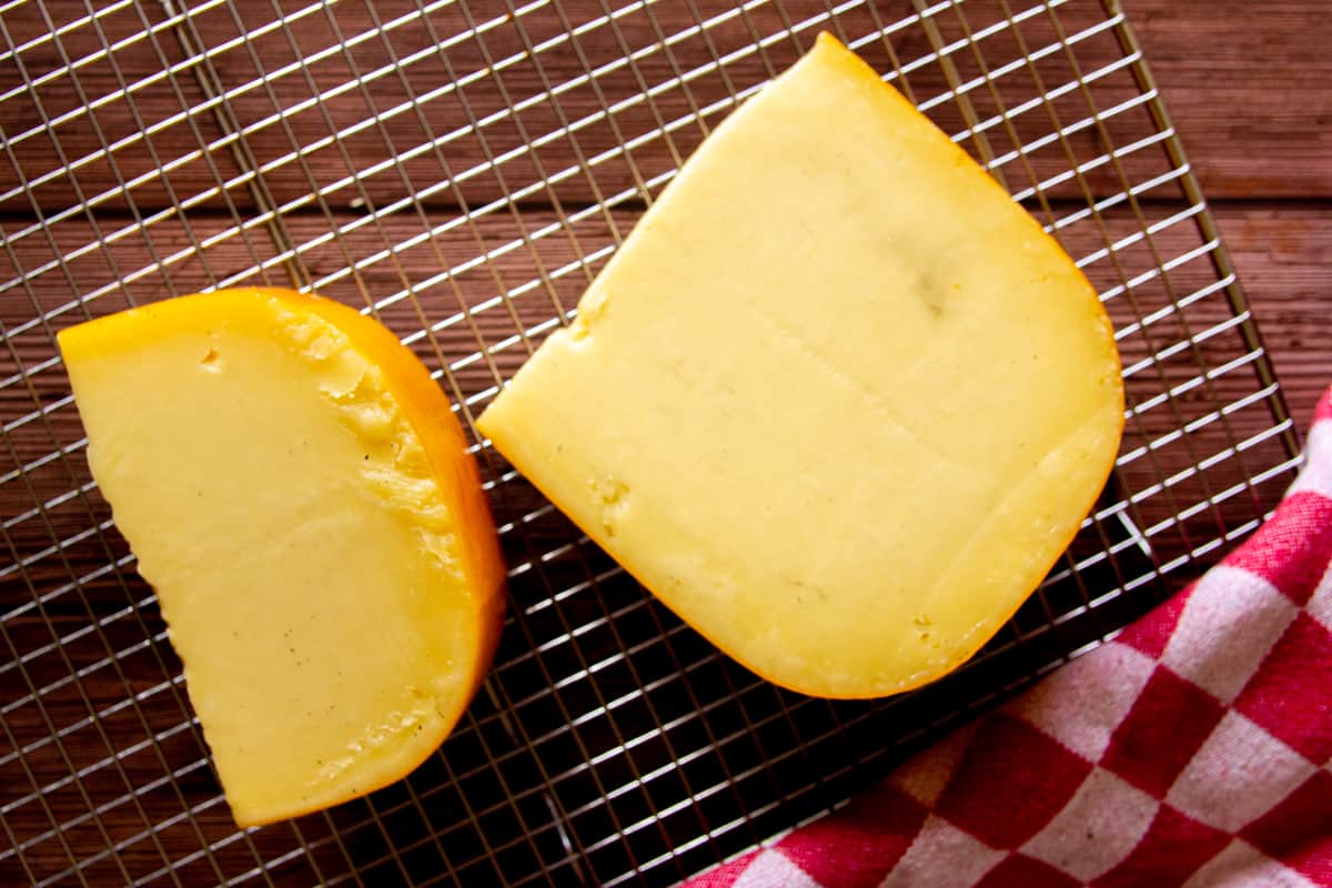 The finished smoked gouda on a resting rack.