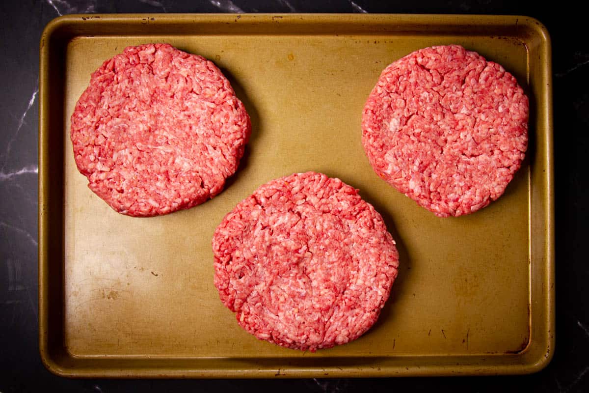Forming the burger patties on a tray.