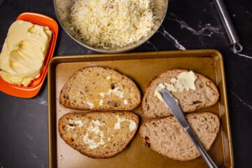 Buttering the bread.