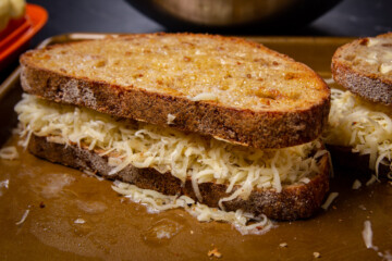 The sandwich loaded with cheese.
