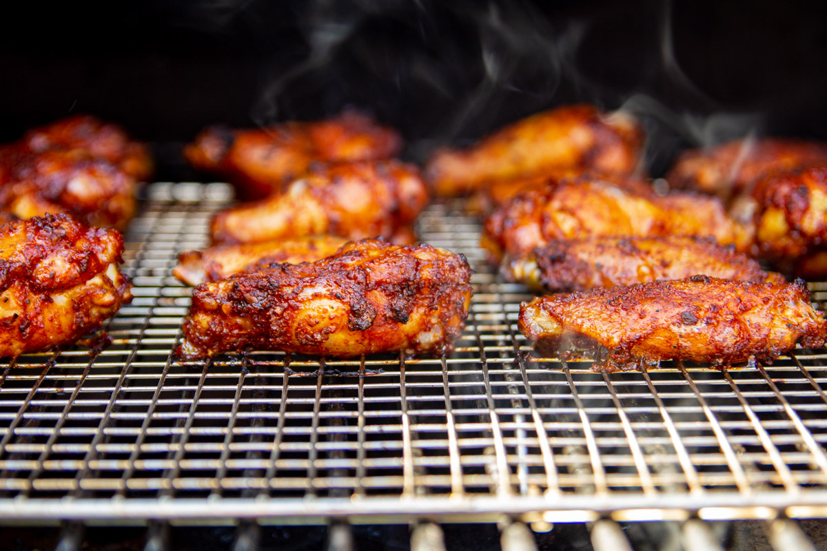 A close up shot of the wings on the smoker.