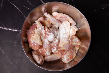 Adding the tsp of baking powder to the wings.