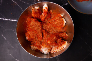 Coating the ribs in the dry rub.