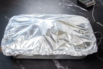 The chuck roast covered in aluminum foil.