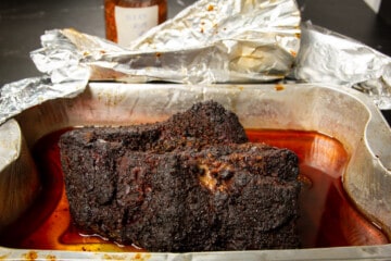 Allowing the meat to rest in the foil.