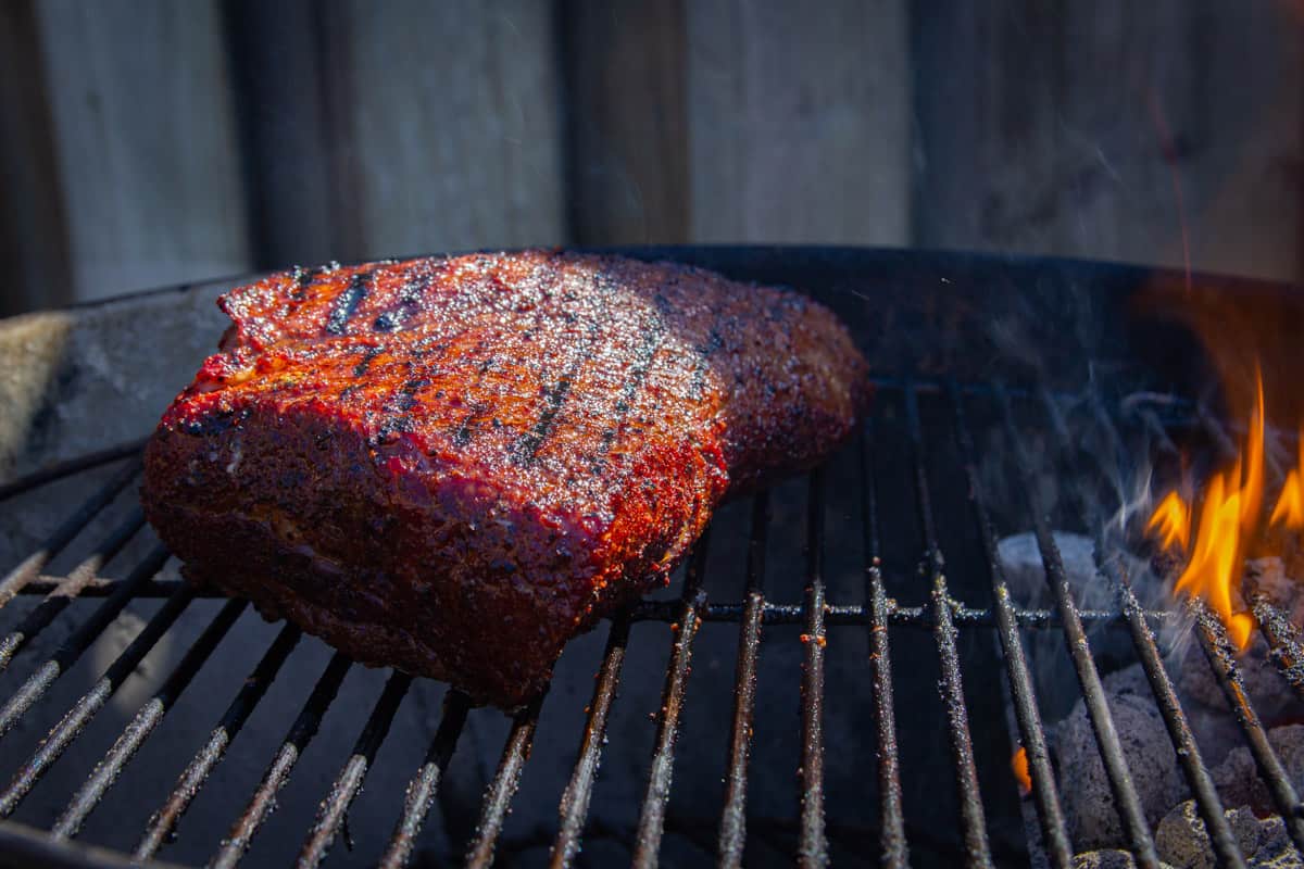 Searing the tri tip over the charcoal grill.